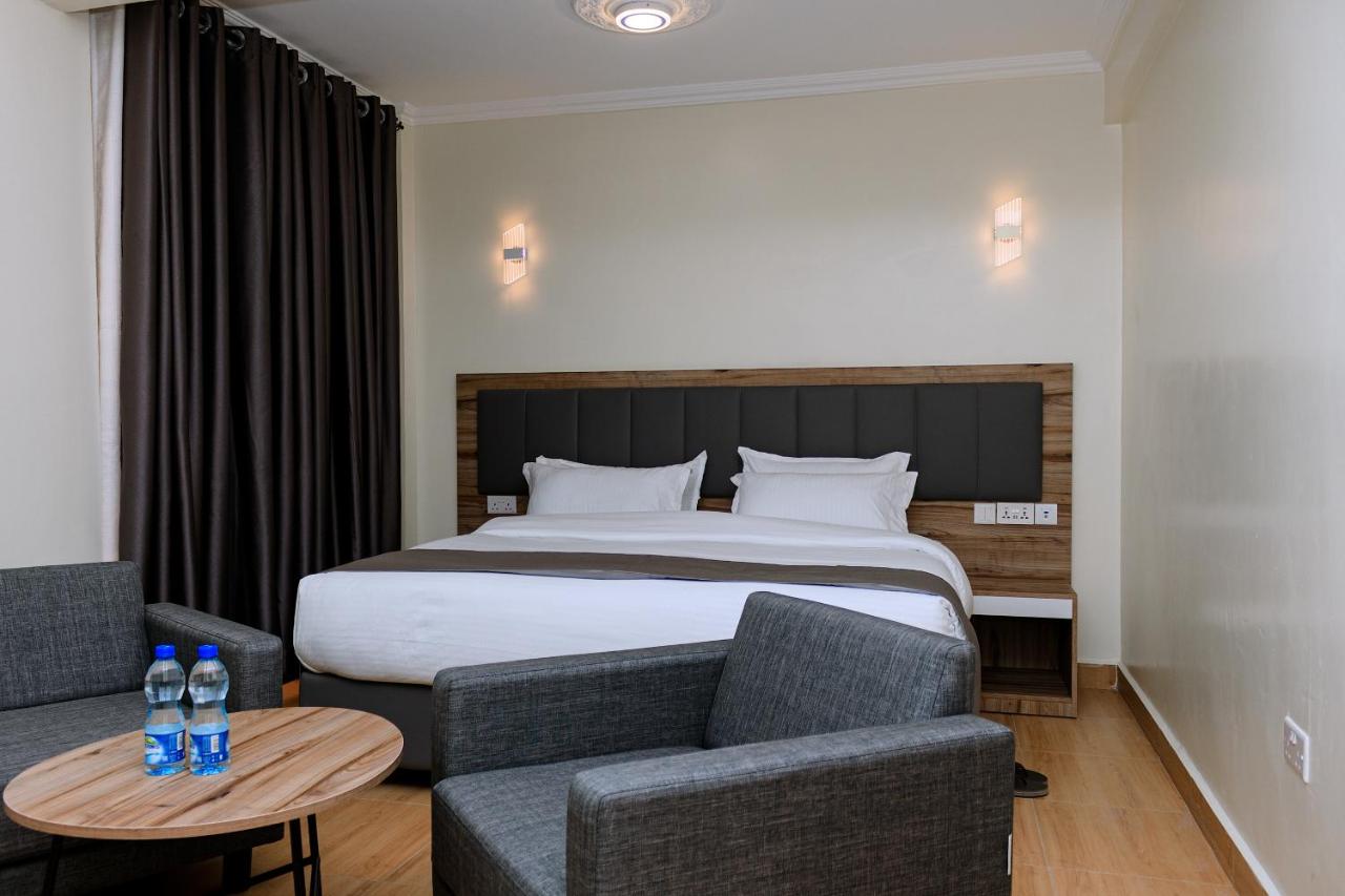 A guest room with an armchair and a canopy view